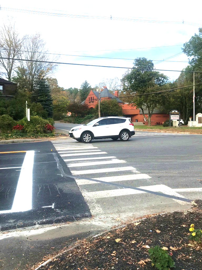Figure 14 - Lack of Pedestrian Facilities on Southwest Intersection Corner leading to Great Road (Route 117) Crosswalk. Image is an aerial close-up of where the crosswalk meets the bed of mulch and vegetation, showing that the corner does not include sidewalks or any other pedestrian accommodations. Figure 14 - Lack of Pedestrian Facilities on Southwest Intersection Corner leading to Great Road (Route 117) Crosswalk. Image is an aerial close-up of where the crosswalk meets the bed of mulch and vegetation, showing that the corner does not include sidewalks or any other pedestrian accommodations.